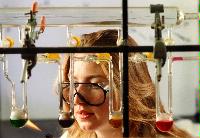 A set of images of unknown students performing chemistry experiments.